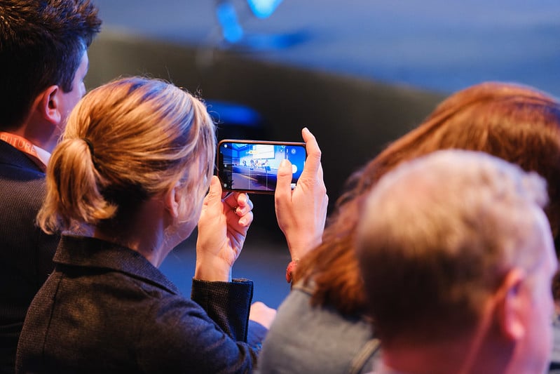 Attendee taking photo at energy industry and water industry event